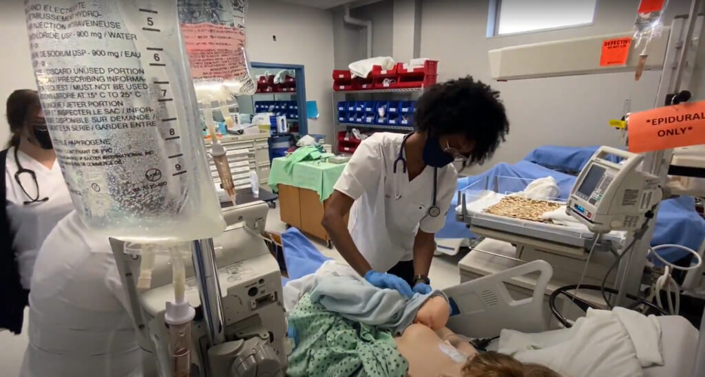 Nursing student practicing on a patient mannequin.