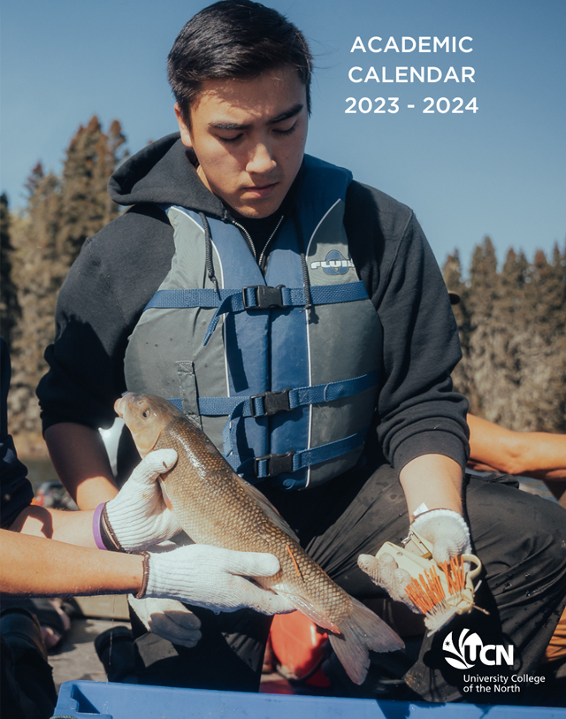 Cover page for the Academic Calendar. Picture of NRMT student holding a fish that is going to be tagged.