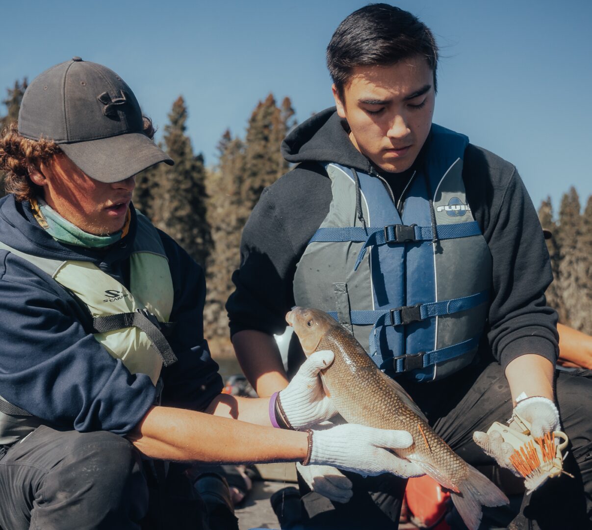 NRMT Students holding a fish that they are going to tag.