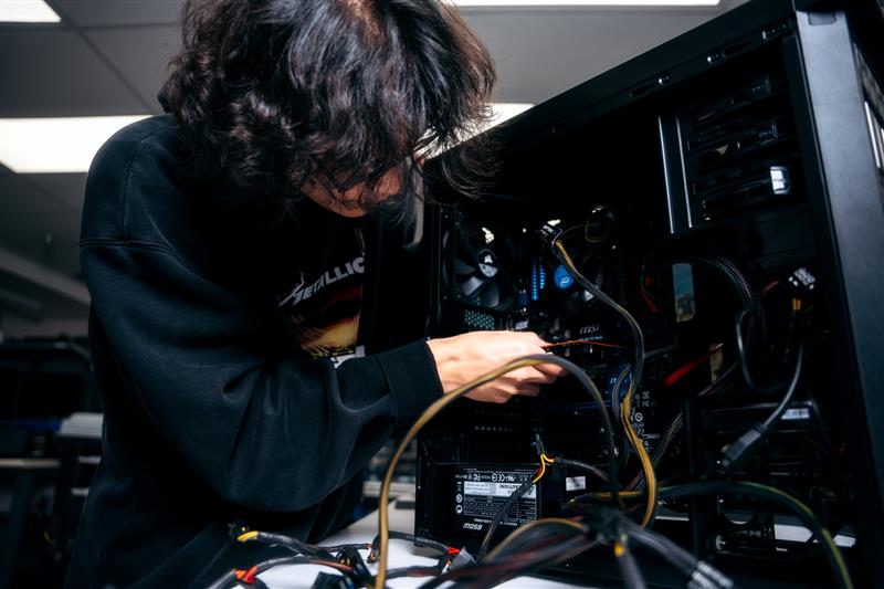 IT Tech Student fixing computer.